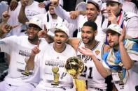 Jun 15, 2014; San Antonio, TX, USA; San Antonio Spurs forward Kawhi Leonard (2), guard Tony Parker (9), forward Tim Duncan (21) and guard Manu Ginobili (20) celebrate with the Larry O'Brian Trophy after game five of the 2014 NBA Finals at AT&T Center. Bob Donnan-USA TODAY Sports