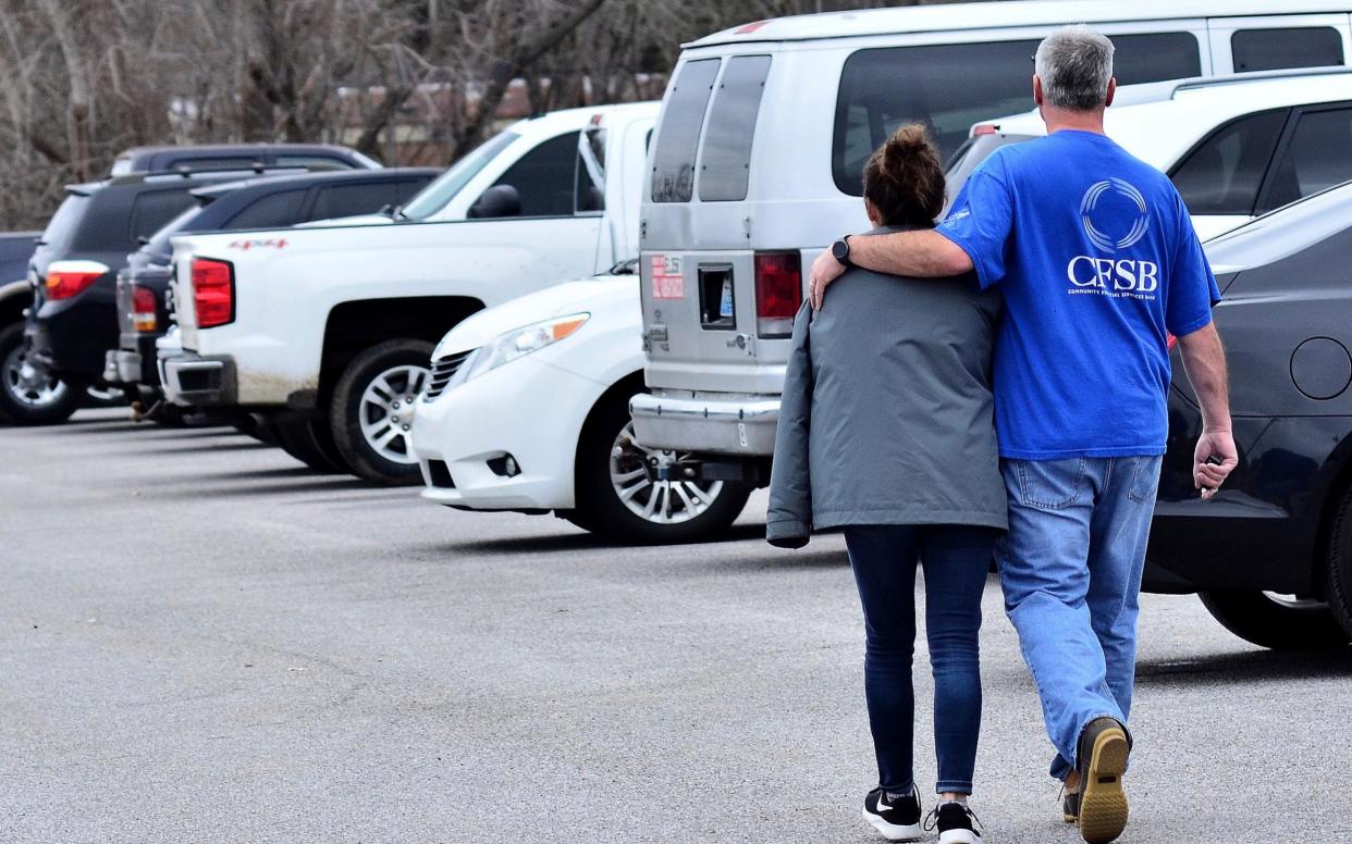 Family members escort their children out of Marshal North Middle School near Palma, Kentucky - FR170568 AP