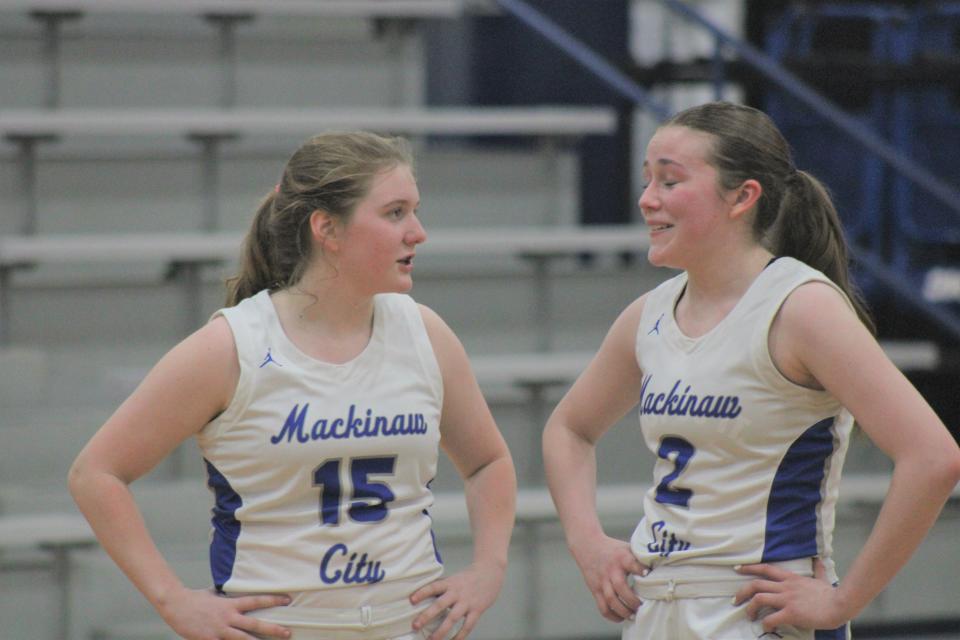 Freshman Kenzlie Currie (15) and senior Grace Sroka (2) have both thrived in their roles with the Mackinaw City girls basketball team this season.