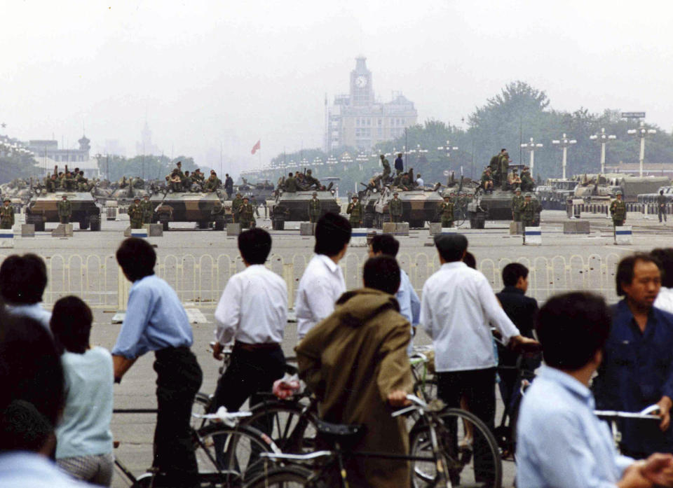 FILE - Curious residents gather to look at the military hardware in Tiananmen Square, Beijing, June 7, 1989, after soldiers and tanks had cleared the square of striking students. An exhibit will open Friday, June 2, 2023, in New York, ahead of the June 4 anniversary of the violence that ended China's 1989 Tiananmen protests. (AP Photo/Mikami, File)