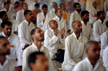 Followers of Asaram Bapu attend a special prayer for his acquittal, before a court convicted him for raping a teenage girl, inside his ashram in Ahmedabad, India, April 25, 2018. REUTERS/Amit Dave