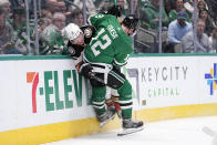 Anaheim Ducks defenseman John Klingberg (3) is slammed against the boards by Dallas Stars' Radek Faksa (12) as the two chase the puck in the first period of an NHL hockey game, Monday, Feb. 6, 2023, in Dallas. (AP Photo/Tony Gutierrez)