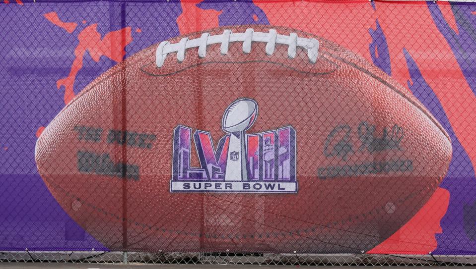 An image of a football with a Super Bowl LVIII logo covers a fence at Allegiant Stadium on Feb. 1, 2024, in Las Vegas. The game will be played on Feb. 11, 2024, between the Kansas City Chiefs and the San Francisco 49ers.