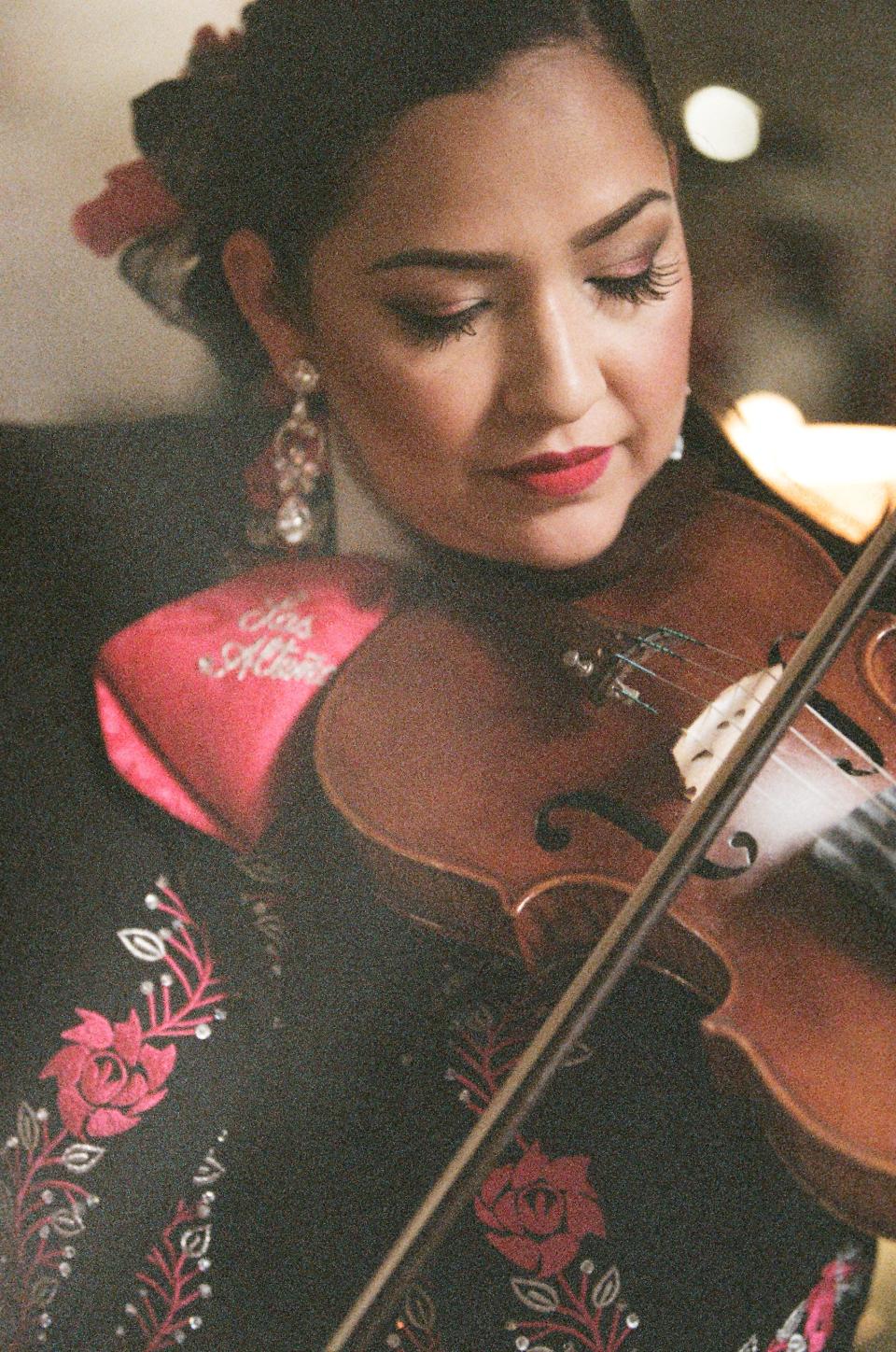 <cite class="credit">Angela Campos plays her violin at a quinceañera.</cite>