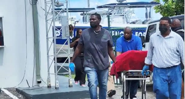 PHOTO: The body of a migrant who died after their vessel capsized off the coast of The Bahamas is taken away by mortuary workers in Nassau, Bahamas July 24, 2022 (ABC News)