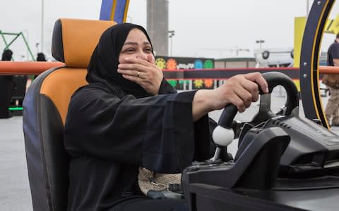  Saudi woman uses a driving simulator at an event to promote the lifting of Saudi Arabia's women's driving ban - Credit: Sam Tarling for The Telegraph