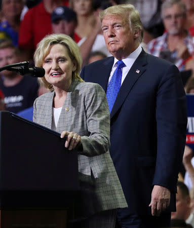 FILE PHOTO: U.S. Senator Cindy Hyde-Smith (R-MS) joins President Donald Trump onstage at a campaign rally in Southaven, Mississippi, U.S., October 2, 2018. REUTERS/Jonathan Ernst/File Photo