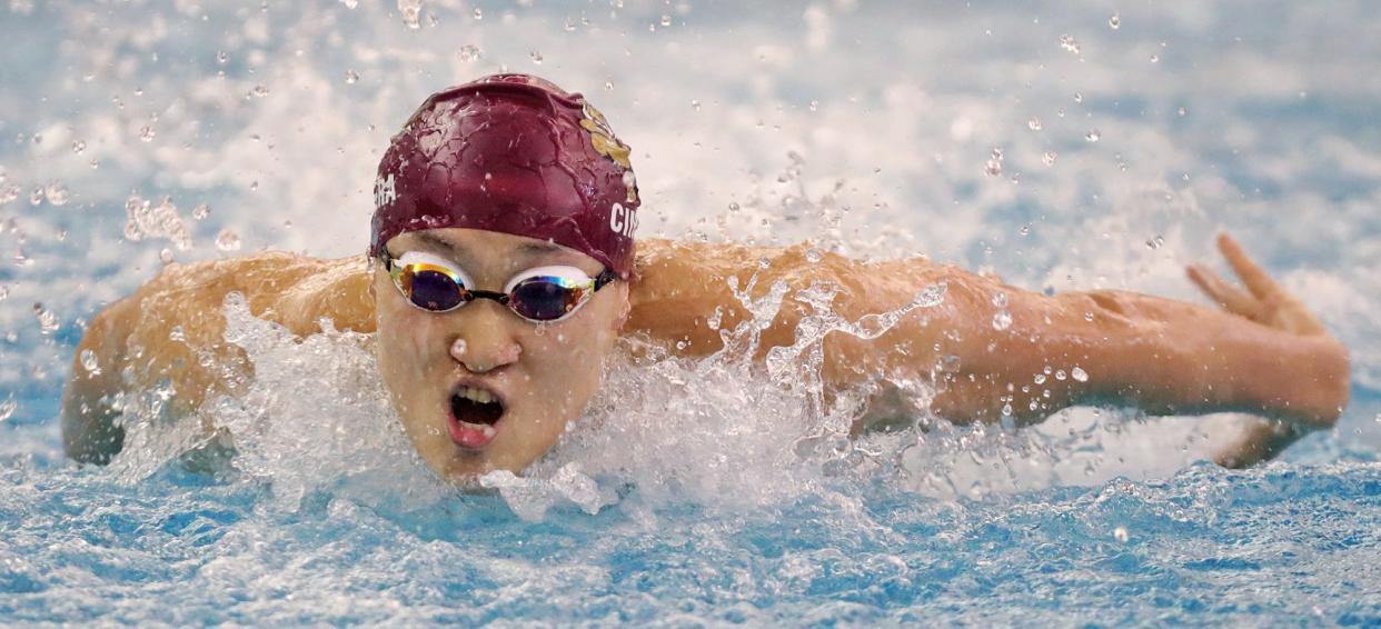 Stow senior Alex Cimera competes in the boys 100-yard butterfly during the Suburban League National Conference Championship at the University of Akron's Ocasek Natatorium.