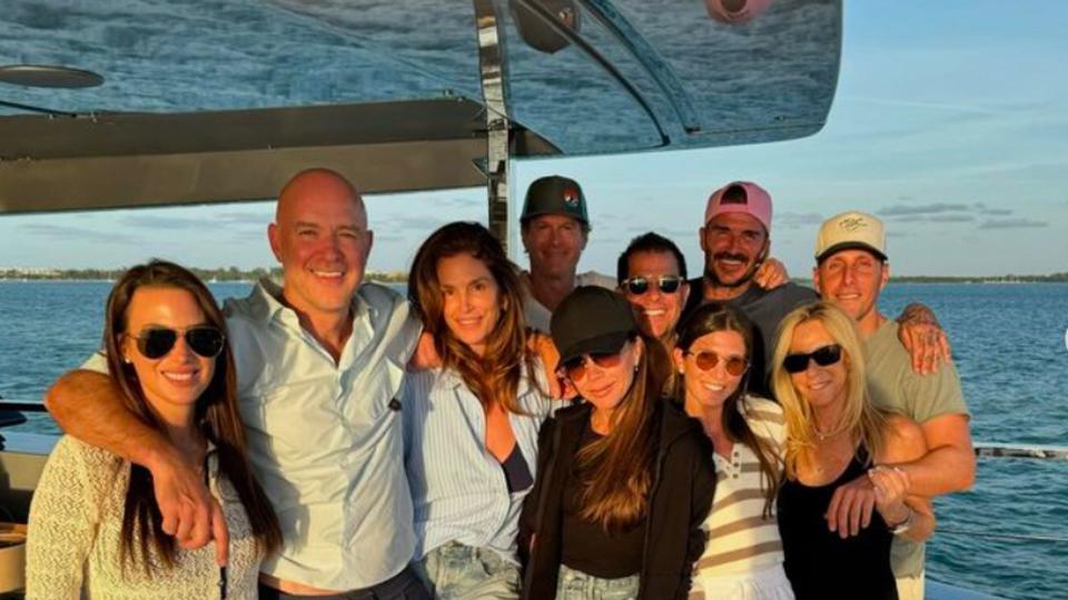 Victoria Beckham and David Beckham on a boat with several friends