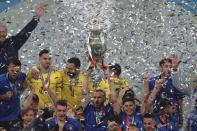 Italian team celebrates with the trophy after the Euro 2020 soccer final match between England and Italy at Wembley stadium in London, Sunday, July 11, 2021. (Catherine Ivill/Pool via AP)