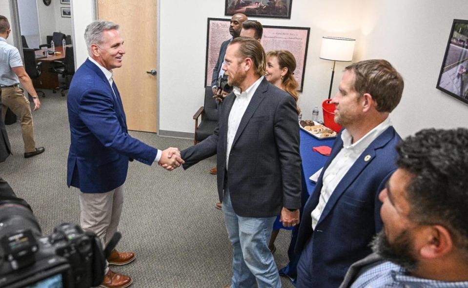 U.S. Congressman and Speaker of the House Kevin McCarthy, left, shakes hands with Fresno County Supervisor Nathan Magsig during a meet-and-greet with local leaders and VIPs at the speaker’s Clovis office on Thursday, Aug. 3, 3023. CRAIG KOHLRUSS/ckohlruss@fresnobee.com
