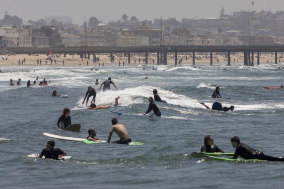 Holiday beachgoers pictured at Venice Beach on Memorial Day as coronavirus safety restrictions continue being relaxed across the state (Getty Images)