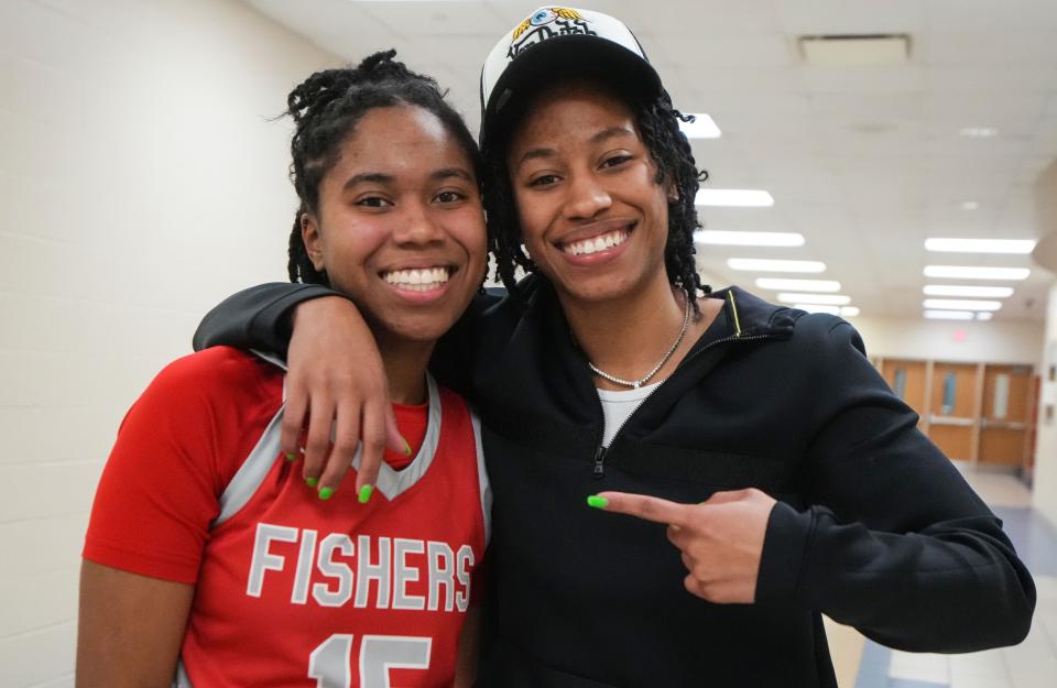 Connecticut Sun's Ty Harris hugs Fishers Tigers Talia Harris (15) on Tuesday, Jan. 16, 2024, during the game at Fishers High School in Fishers. The Fishers Tigers defeated the Carmel Greyhounds, 44-37.