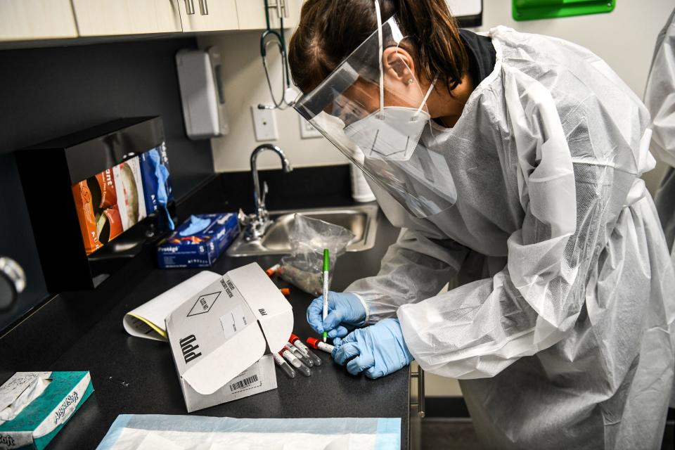 Nurse Practitioner Gabriela Huyke prepares for medical examination of a volunteer for the COVID-19 vaccine study at the Research Centers of America (RCA) in Hollywood, Florida, on August 13, 2020. - So-called phase three vaccine clinical trials, in which thousands of people take part in the final stages, are gaining traction in Florida. With more than half a million cases and over 9,000 deaths, Florida ranks second in the US in total cases behind California, making it an ideal place to carry out the trials. That has led to a flurry of activity at the RCA, a private center carrying out clinical trials in Hollywood, 25 miles (40kms) north of Miami. (Photo by CHANDAN KHANNA / AFP) (Photo by CHANDAN KHANNA/AFP via Getty Images)