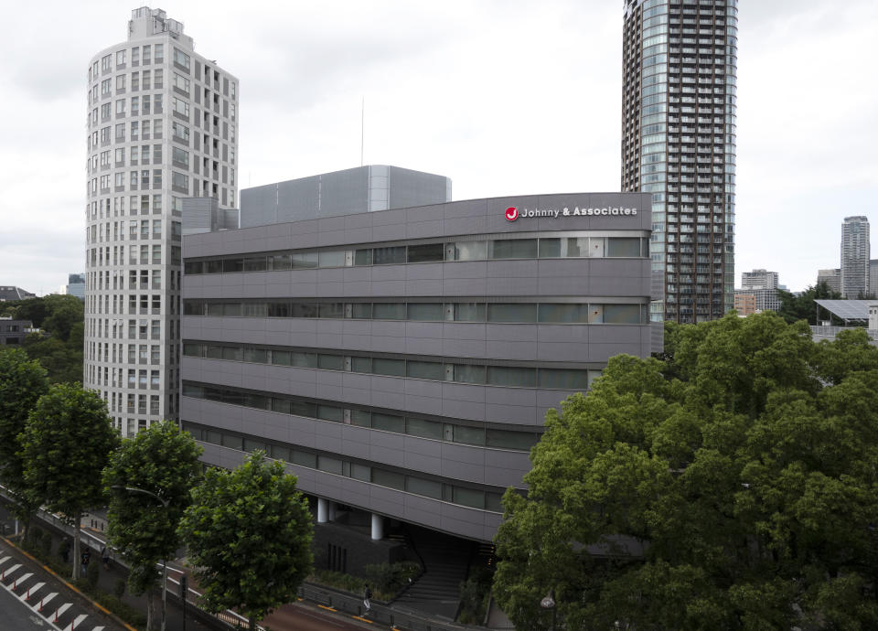 A sign hangs on the facade of the headquarters of Johnny & Associates talent agency founded by Johnny Kitagawa Wednesday, July 10, 2019, in Tokyo. Kitagawa, who produced famous boybands including Arashi and SMAP and was a kingpin of Japan’s entertainment industry for more than half a century, has died Tuesday from a subarachnoid hemorrhage at a Tokyo hospital. He was 87. (AP Photo/Jae C. Hong)