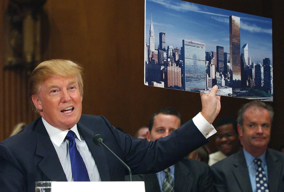 FILE - In this July 21, 2005, file photo, Donald Trump holds a picture of the New York City skyline while testifying on renovation of the United Nations Headquarters on Capitol Hill. When President Donald Trump visits the United Nations building in New York, he’s not just thinking about the global challenges the world body faces, he’s still got in mind the deal that got away. More than a decade later, Trump still relives the overtures he made to rebuild the 39-story tower in the early 2000s and posits that he could have done a better job of it. (AP Photo/Dennis Cook, file)