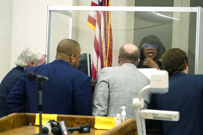 Hinds County Circuit Judge Adrienne Wooten, sits behind her protective barrier as she confers with the state's attorneys and defense attorneys for John Davis, former director of the Mississippi Department of Human Services in Jackson, Miss., on Thursday, Sept. 22, 2022. Davis pleaded guilty to new federal charges in a conspiracy to misspend tens of millions of dollars that were intended to help needy families in one of the poorest states in the U.S. — part of the largest public corruption case in the state's history.(AP Photo/Rogelio V. Solis)