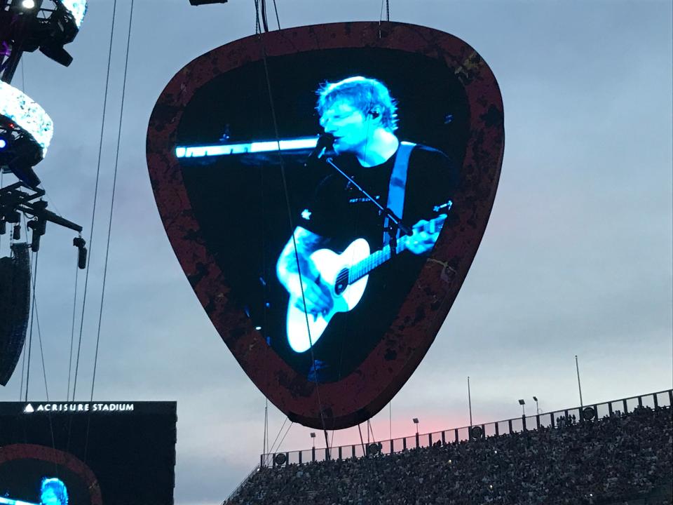 Guitar pick-shaped video screens at the Ed Sheeran show.