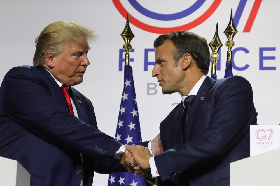 French President Emmanuel Macron shakes Trump's hands during a joint press conference in Biarritz on Monday. (Photo: LUDOVIC MARIN via Getty Images)