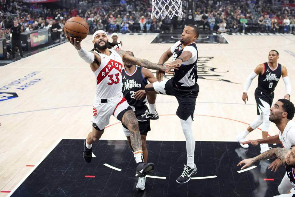 Toronto Raptors guard Gary Trent Jr. (33) shoots as Los Angeles Clippers guard Norman Powell (24) and forward Kawhi Leonard (2) defend during the first half of an NBA basketball game Wednesday, Jan. 10, 2024, in Los Angeles. (AP Photo/Mark J. Terrill)