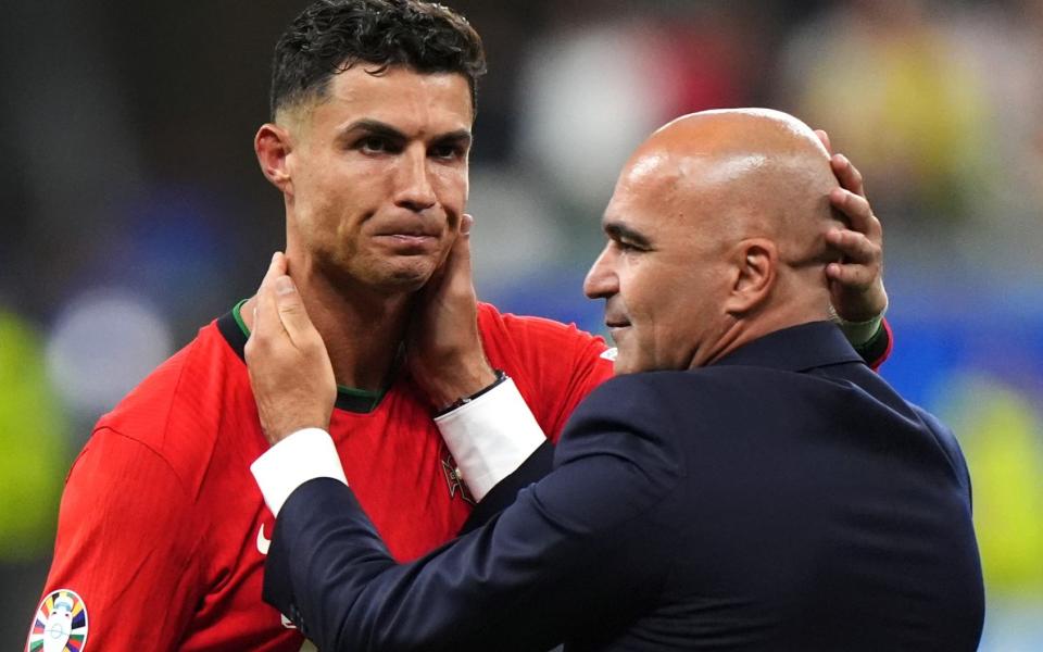 Roberto Martinez holds a crying Cristiano Ronaldo by the face