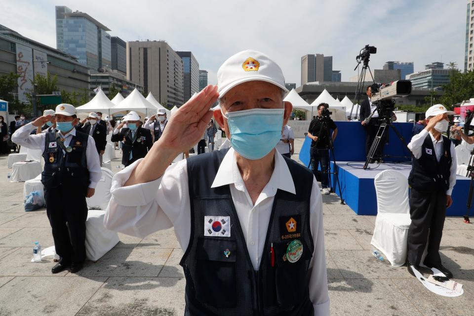 Korean War veterans of South Korea salute during a ceremony to unveil an installation artwork to commemorate the upcoming 70th anniversary of the Korean War, in Seoul, South Korea, Monday, June 15, 2020. South Korea on Sunday convened an emergency security meeting and urged North Korea to uphold reconciliation agreements, hours after the North threatened to demolish a liaison office and take military action against its rival. (AP Photo/Ahn Young-joon)