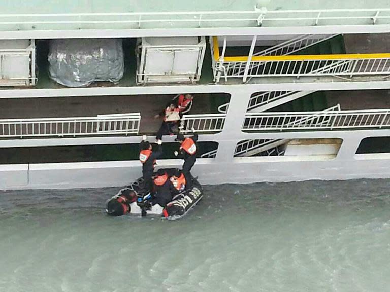 The South Korean Coast Guard rescue some of the passengers from a ferry sinking some 20 kilometres off the island of Byungpoong in Jindo on April 16, 2014, in this South Korea Coast Guard image