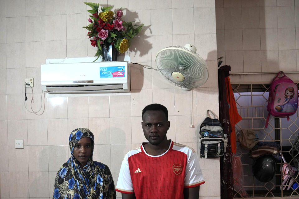 Morwan Mohammad and his wife Nagad Daoud Abdallah, who fled war in Sudan, pose for a photograph in their room at a hotel turned into a shelter for refugees, in Batam, an island in northwestern Indonesia, Thursday, May 16, 2024. They are among hundreds of refugees living in community housing on the island while waiting for resettlement in a third country. All three of Mohammad's children were born in Indonesia and he does not know where his family will ultimately settle. (AP Photo/Dita Alangkara)