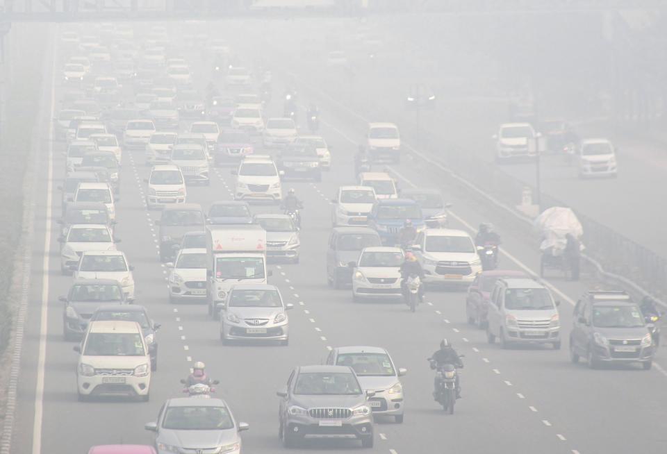 Vehicles move slowly amid low visibility due to dense fog on a cold winter morning, at Delhi-Gurugram Experssway in Gurugram, Friday, 15 January, 2021.