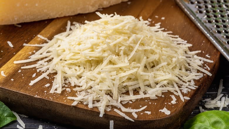 Freshly grated Parmesan cheese on a board