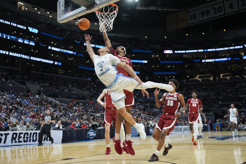 North Carolina guard Seth Trimble (7) shoots past Alabama forward Jarin Stevenson during the first half of a Sweet 16 college basketball game in the NCAA tournament Thursday, March 28, 2024, in Los Angeles. (AP Photo/Ashley Landis)