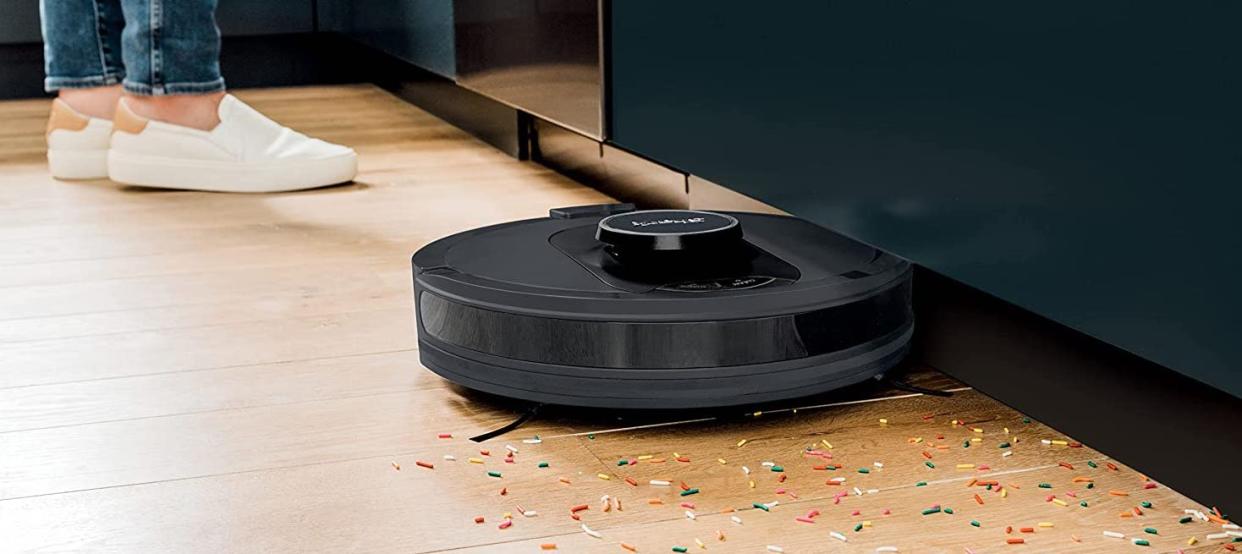 black robot vacuum under sofa