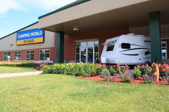 Camping World retail store with RV camper parked out front.