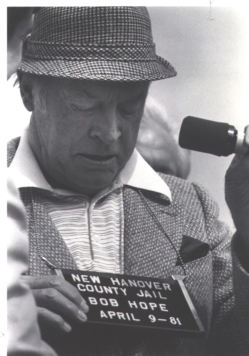 Bob Hope examines a name tag given to him by then-New Hanover County sheriff Tom Radewicz during his 1981 visit as a guest of the N.C. Azalea Festival.