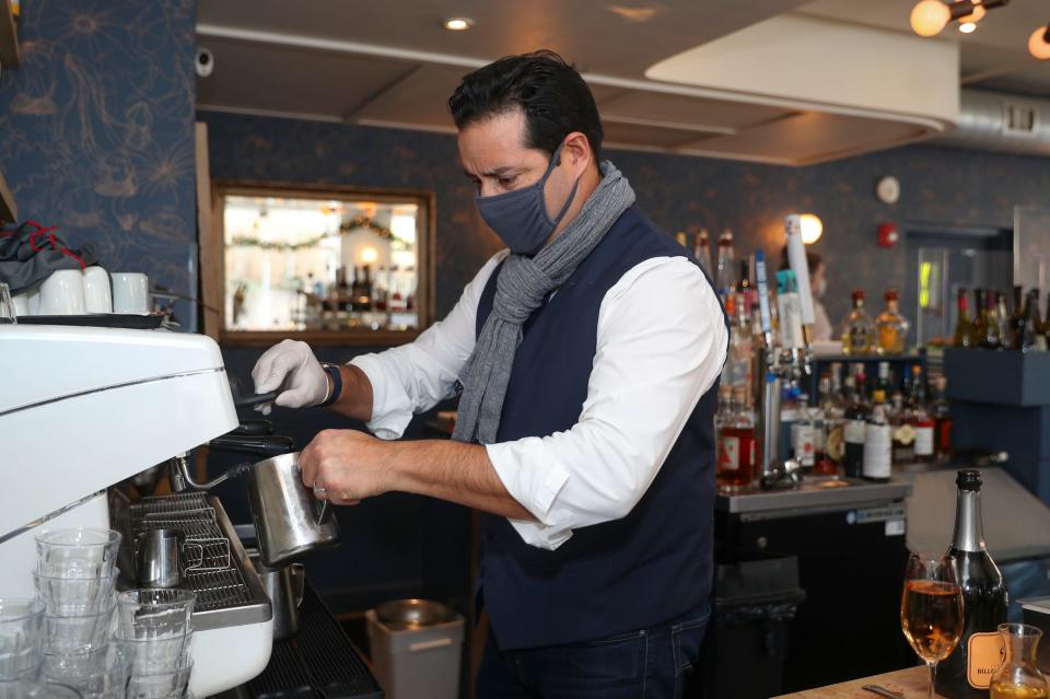 Paul Molakides of Boro6 Wine Bar in Hastings-on-Hudson, New York, prepares a coffee on Friday, January 14, 2022. Boro6 requires patrons to show their vaccination card to eat at the restaurant.