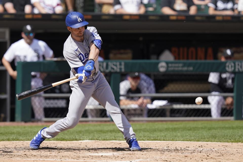 Dodgers' Trea Turner swings into an RBI single off Chicago White Sox pitcher Dylan Cease.