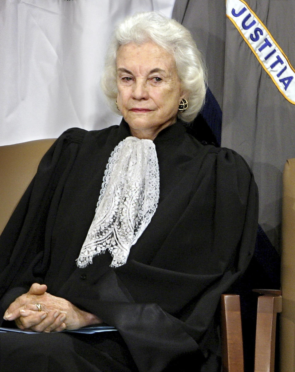 FILE - Supreme Court Associate Justice Sandra Day O'Connor listens to remarks by President Bush and U.S. Attorney General Alberto Gonzales after she administered the oath of office to Gonzales during an installation ceremony at the Justice Department in Washington, Feb. 14, 2005. O'Connor, who joined the Supreme Court in 1981 as the nation's first female justice, has died at age 93. (AP Photo/J. Scott Applewhite, File)
