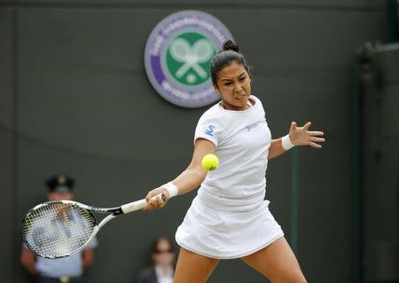 Zarina Diyas of Kazakhstan hits a shot during her match against Maria Sharapova of Russia at the Wimbledon Tennis Championships in London, July 6, 2015. REUTERS/Suzanne Plunkett