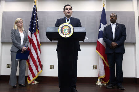 Puerto Rico Governor Roberto Rossello (C) addresses the media next to Homeland Security Secretary Kirstjen Nielsen (L) and Housing and Urban Development Secretary Ben Carson, after Hurricane Maria's devastation, in San Juan, Puerto Rico, December 19, 2017. REUTERS/Alvin Baez