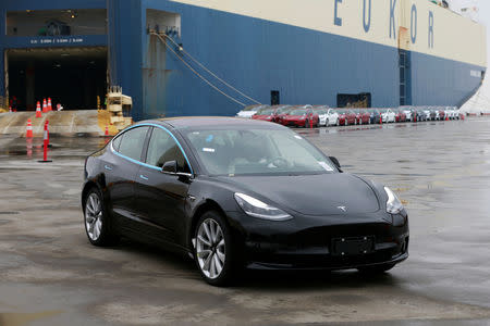 A Tesla Model 3 car leaves a cargo vessel at a port in Shanghai, China February 22, 2019. REUTERS/Stringer