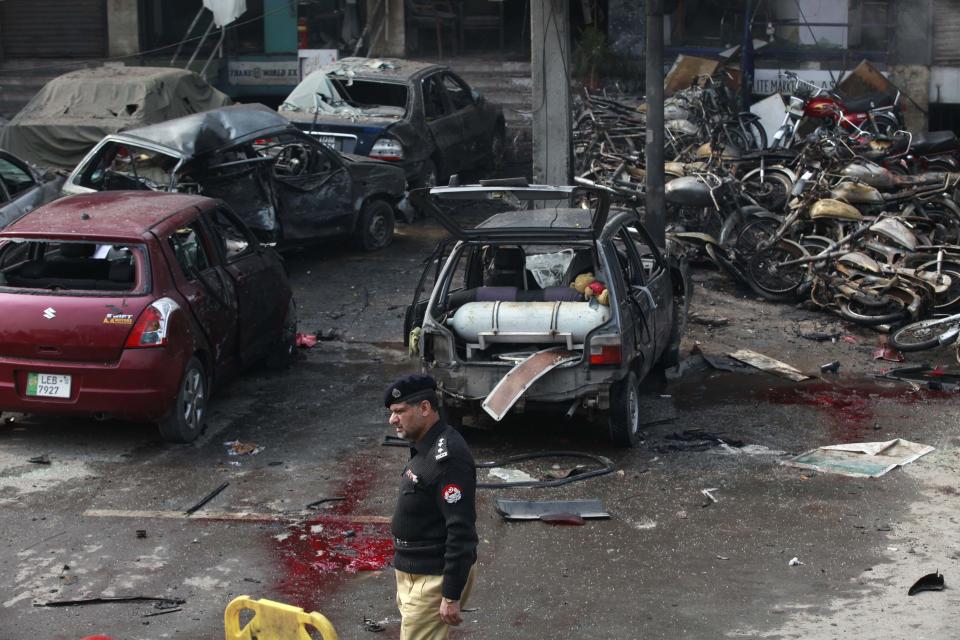 A policeman stands at the site of an explosion outside the police headquarters, in Lahore