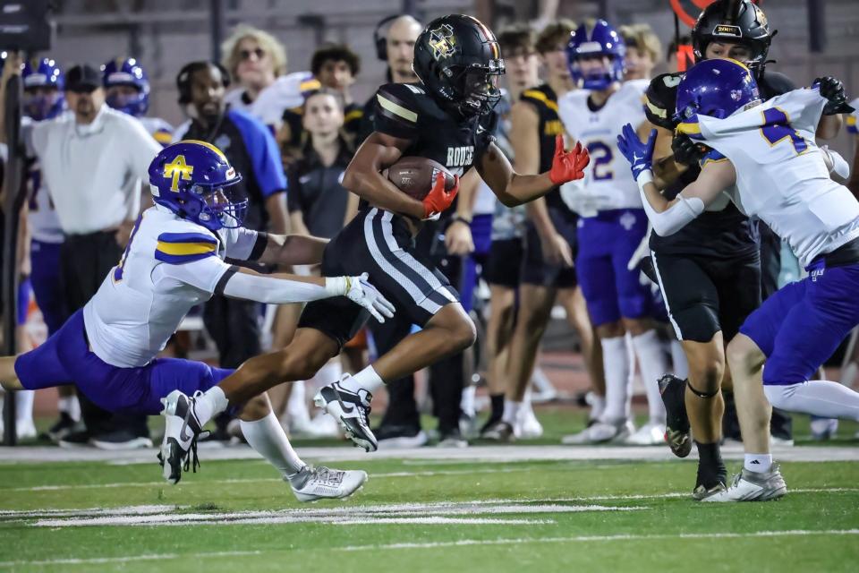 Rouse running back Keller Rogers looks for more yards against Anderson's defense during the Raiders' victory on Friday.