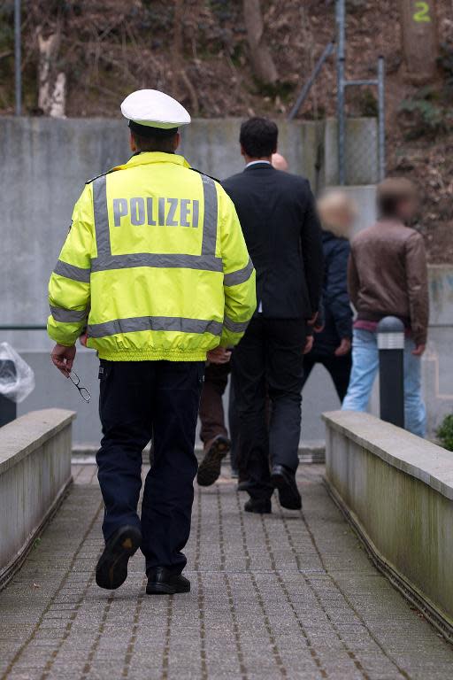 A police officer pictured outside the apartment of Andreas Lubitz, the co-pilot of the crashed Germanwings plane, in Duesseldorf, western Germany, on March 26, 2015