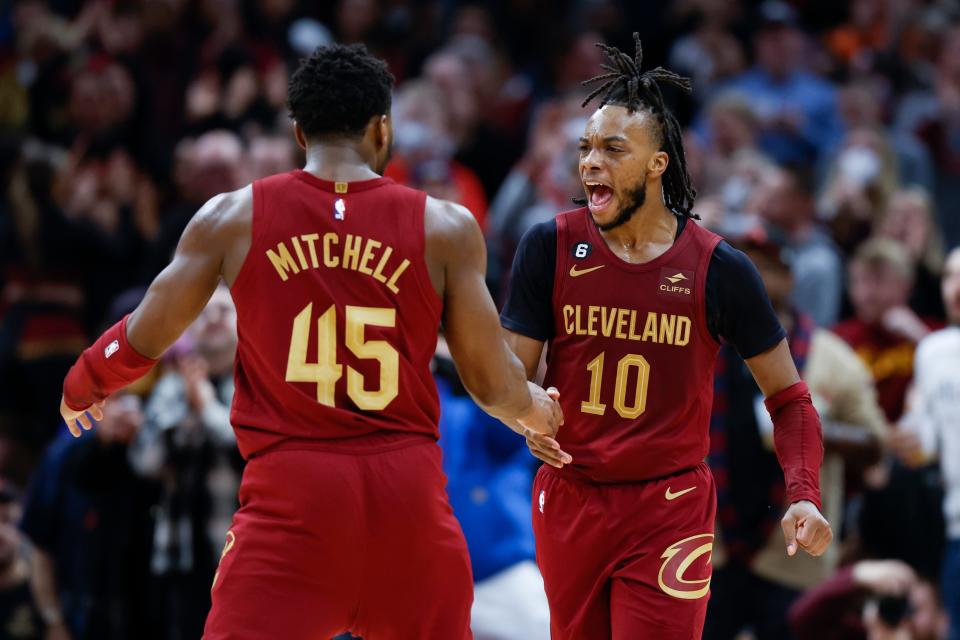 Cleveland Cavaliers guards Darius Garland (10) and Donovan Mitchell (45) celebrate during the second half of an NBA basketball game against the Indiana Pacers, Friday, Dec. 16, 2022, in Cleveland. (AP Photo/Ron Schwane)