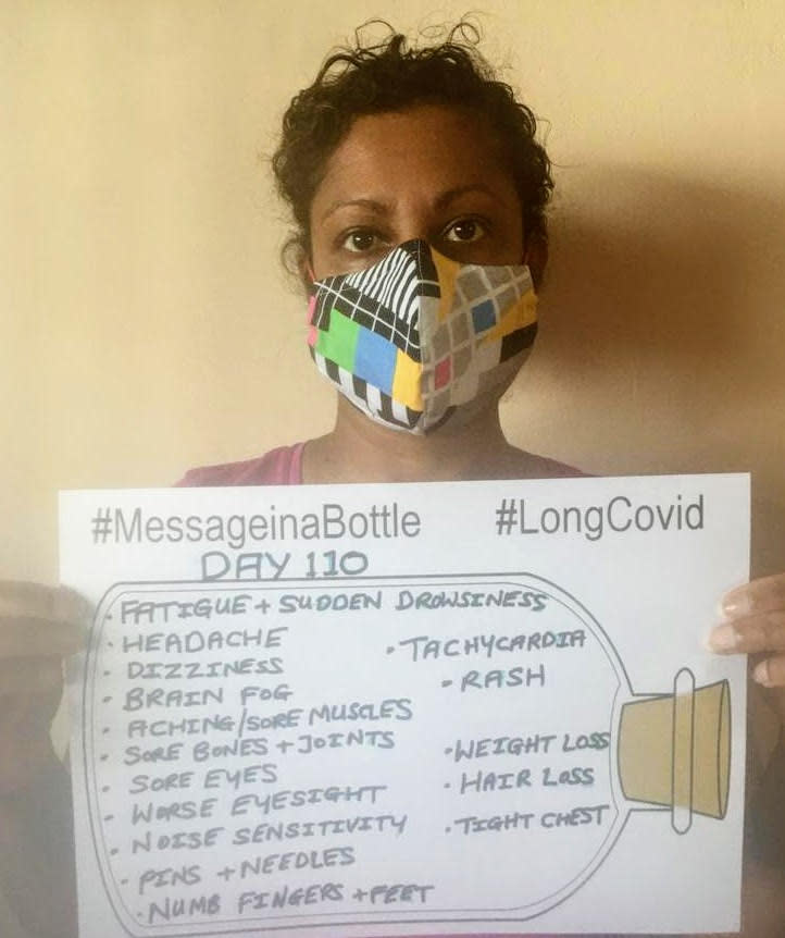 Sheren Gaulbert, 46, is one of many long COVID sufferers. Here, Sheren holds up a list of just some of the symptoms she's experienced. (Supplied)