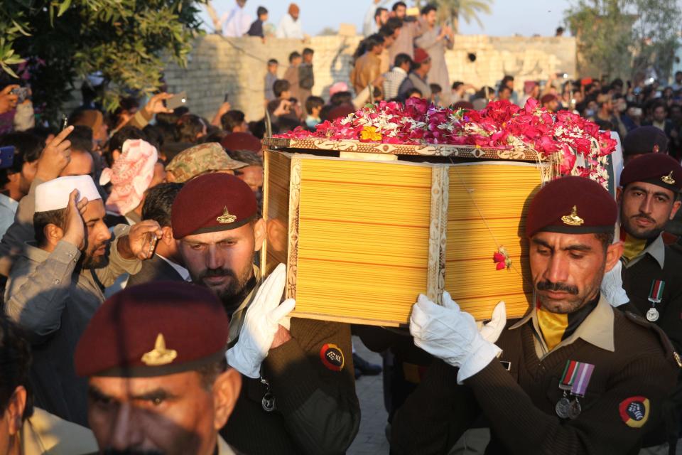 Pakistani soldiers carry a coffin of Pakistani soldier Khuram Ali who reportedly lost his life during heavy shelling from Indian troops at the Line of Control in Pakistani Kashmir, during his funeral in Dera Ghazi Khan in Pakistan, Monday, March 4, 2019. A key train service with neighboring India resumed and schools in Pakistani Kashmir opened Monday in another sign of easing tensions between the two nuclear-armed rivals since a major escalation last week over the disputed Kashmir region. (AP Photo/Asim Tanveer)