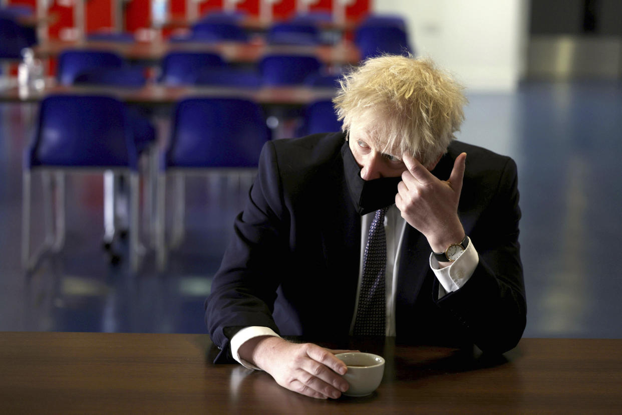 Britain's Prime Minister Boris Johnson speaks with pupils after taking part in a science lesson, during a visit to King Solomon Academy in London, Thursday April 29, 2021.  (Dan Kitwood/Pool via AP)