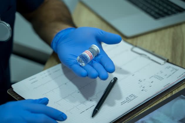 Doctor holds bottle with COVID-19 vaccine in laboratory,Injection,Authorized,Collaborating,Hope,Partners, Pandemic,Global Vaccine Action Plan,COVAX. (Photo: Visoot Uthairam via Getty Images)