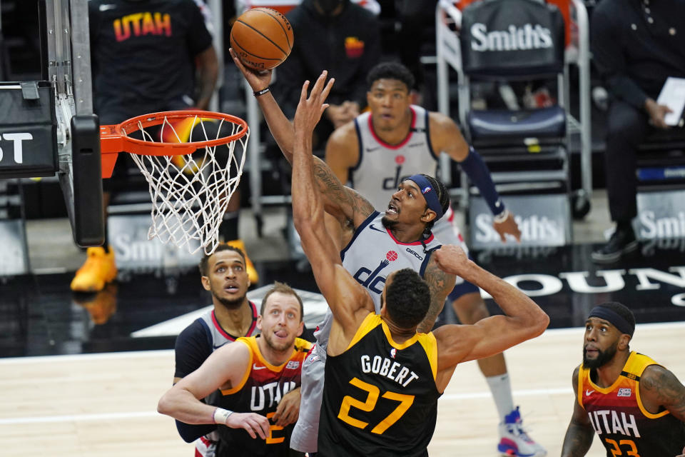 Washington Wizards guard Bradley Beal, rear center, lays the ball up as Utah Jazz center Rudy Gobert (27) defends in the second half during an NBA basketball game Monday, April 12, 2021, in Salt Lake City. (AP Photo/Rick Bowmer)