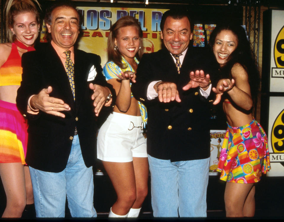 Raphael Ruiz and Antonio Romero of Los Del Rio stand with dancers in a Coconuts music store in New York City in October 1996.